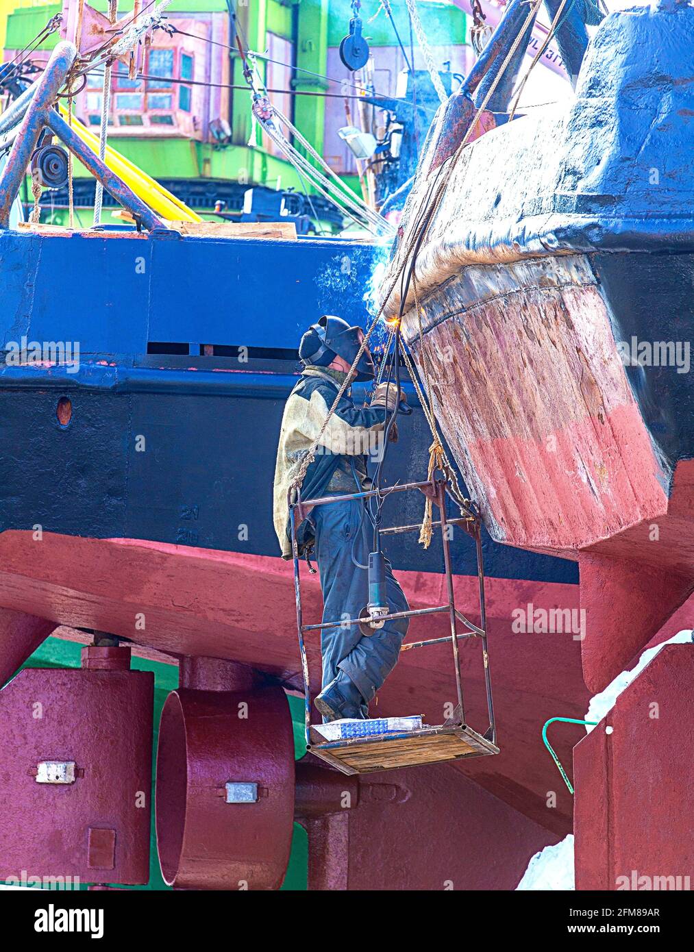 a welder working on a repair ship on Kamchatka Stock Photo