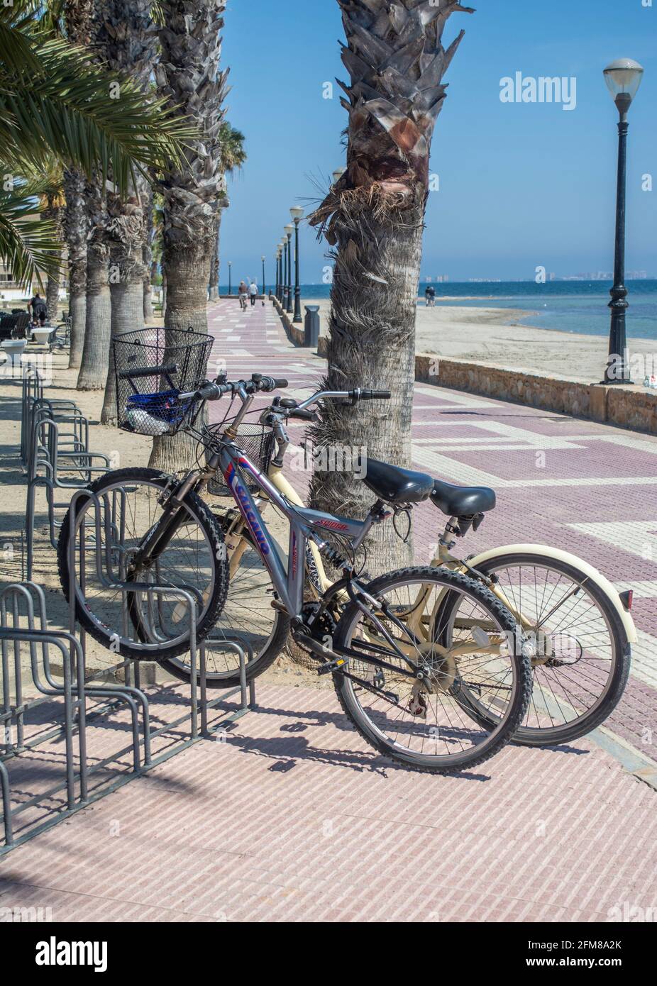 Bycicles in a cycle rack on the promenade at Los Narejos in Murcia Spain Stock Photo