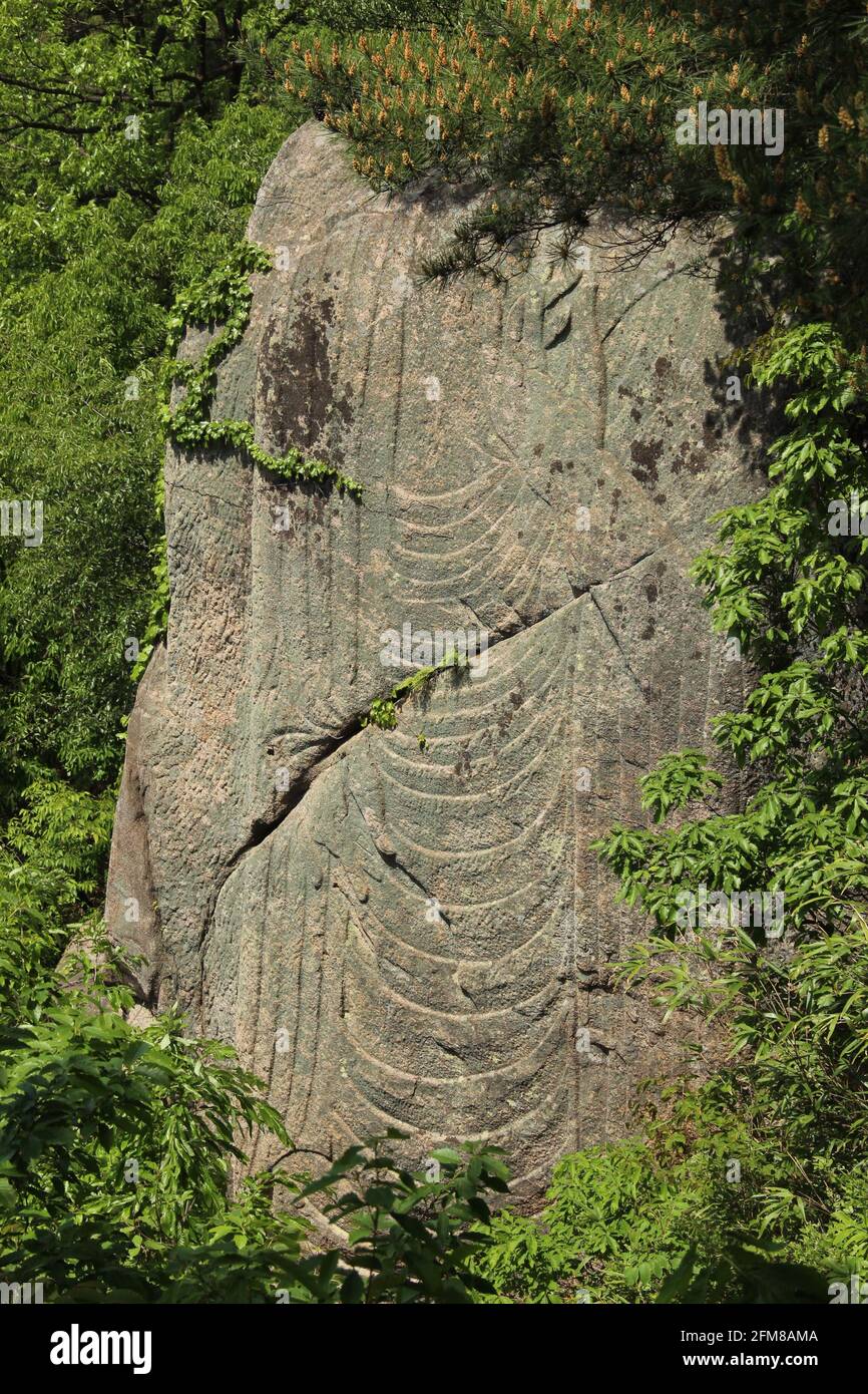 A decapitated buddha carving in a rock on Namsan near Gyeongju in South Korea Stock Photo
