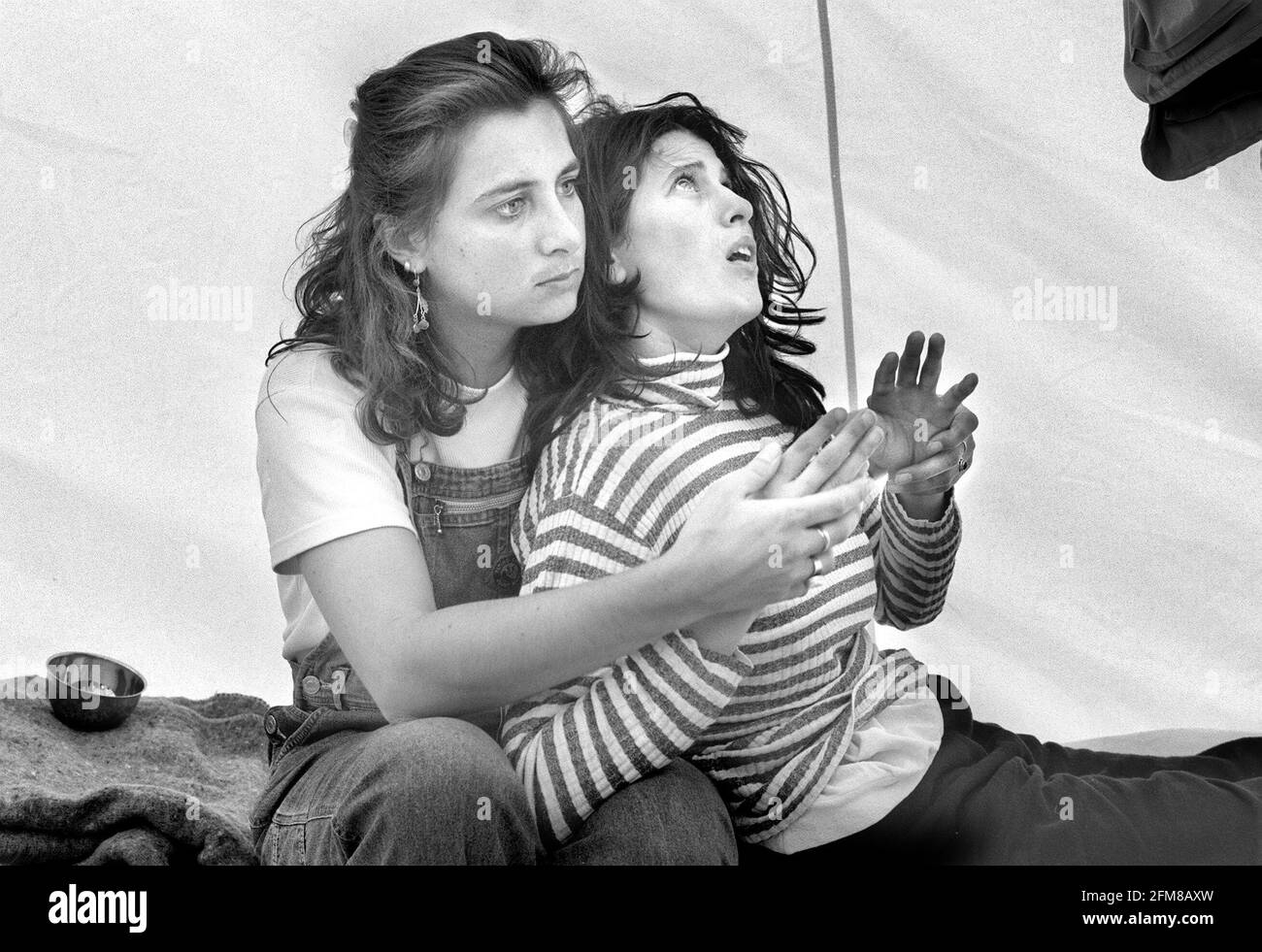 TRAUMERTISED BY HER EXPERIENCES IN KOSOVO A YOUNG WOMAN IS COMFORTED IN THE MDM TENT AT THE ALBANIAN BORDER. Stock Photo