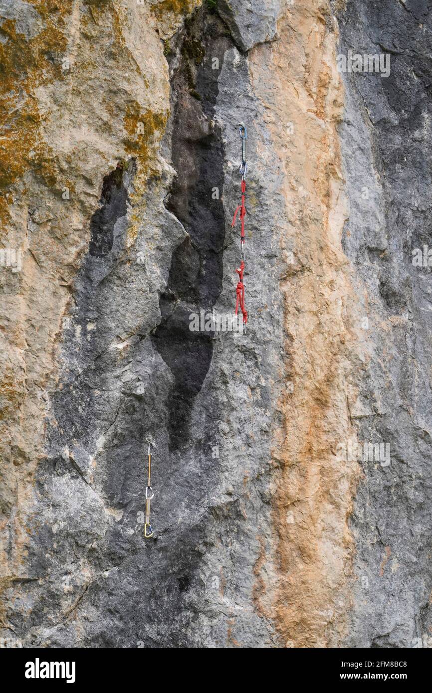 Rock Climbing rope and anchors, left behind hanging on natural rock