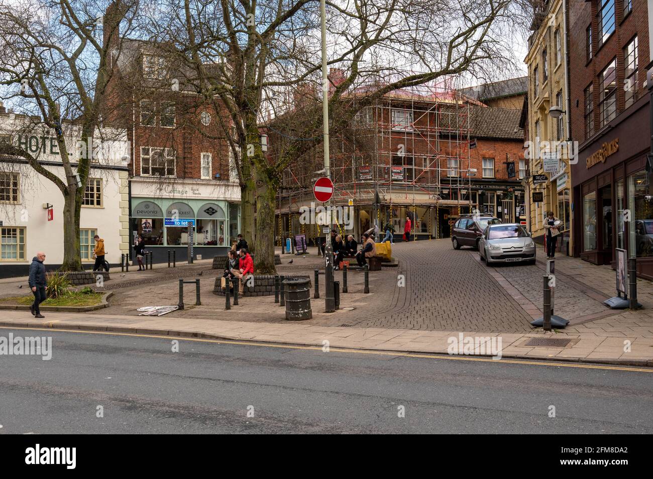 A view of Orford Hill Norwich city centre with people sitting relaxing and eating Stock Photo