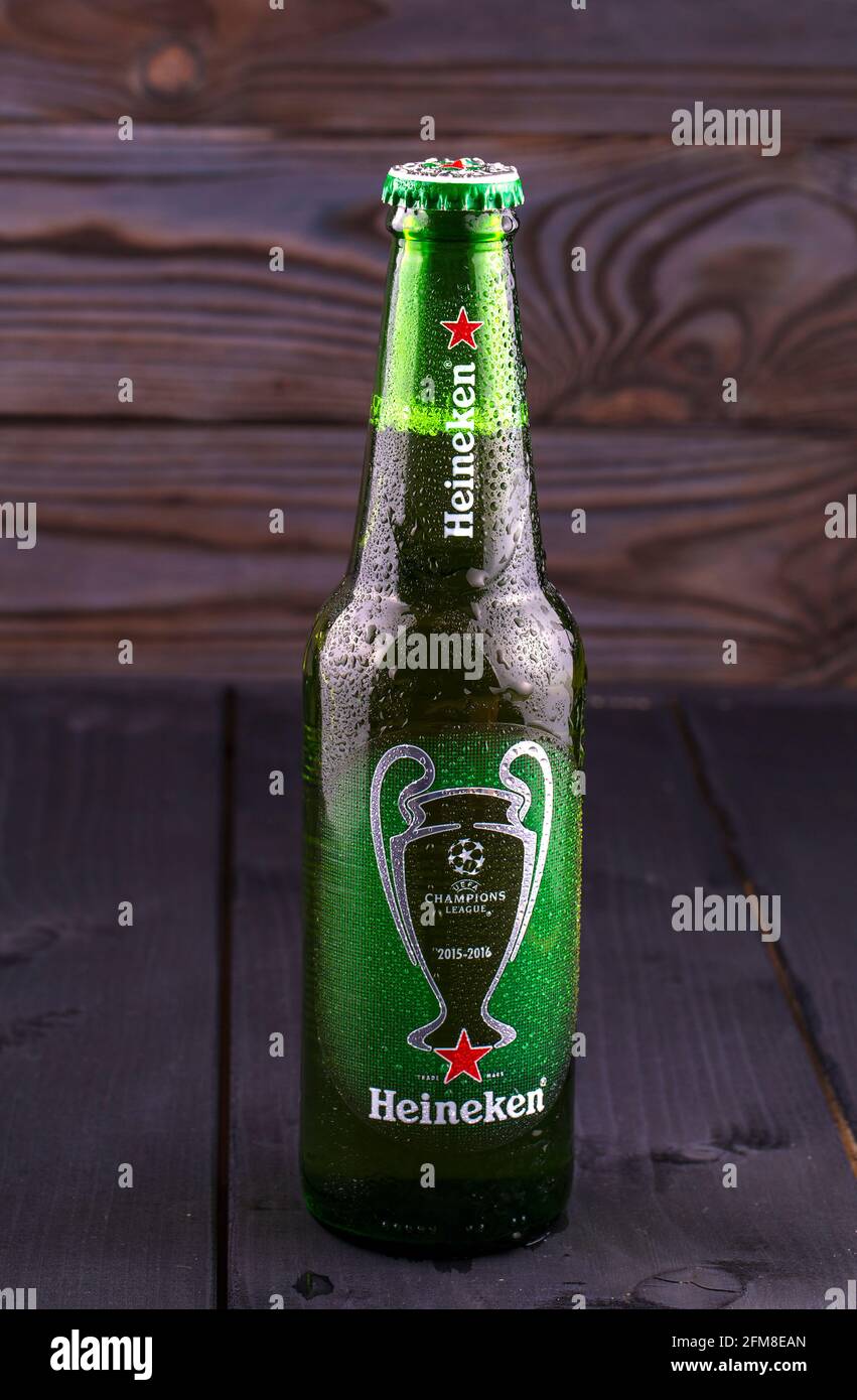 KAMCHATKA- OCTOBER -07, 2016 : Bottle of Heineken beer over wooden background. Special edition for UEFA European Championship. Heineken Lager Beer is Stock Photo