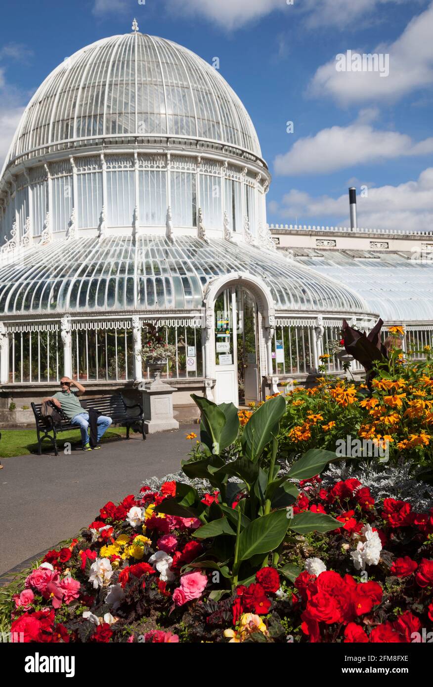 The glasshouse at the Botanical gardens, Belfast, Northern Ireland with the garden laid out with begonias. Stock Photo