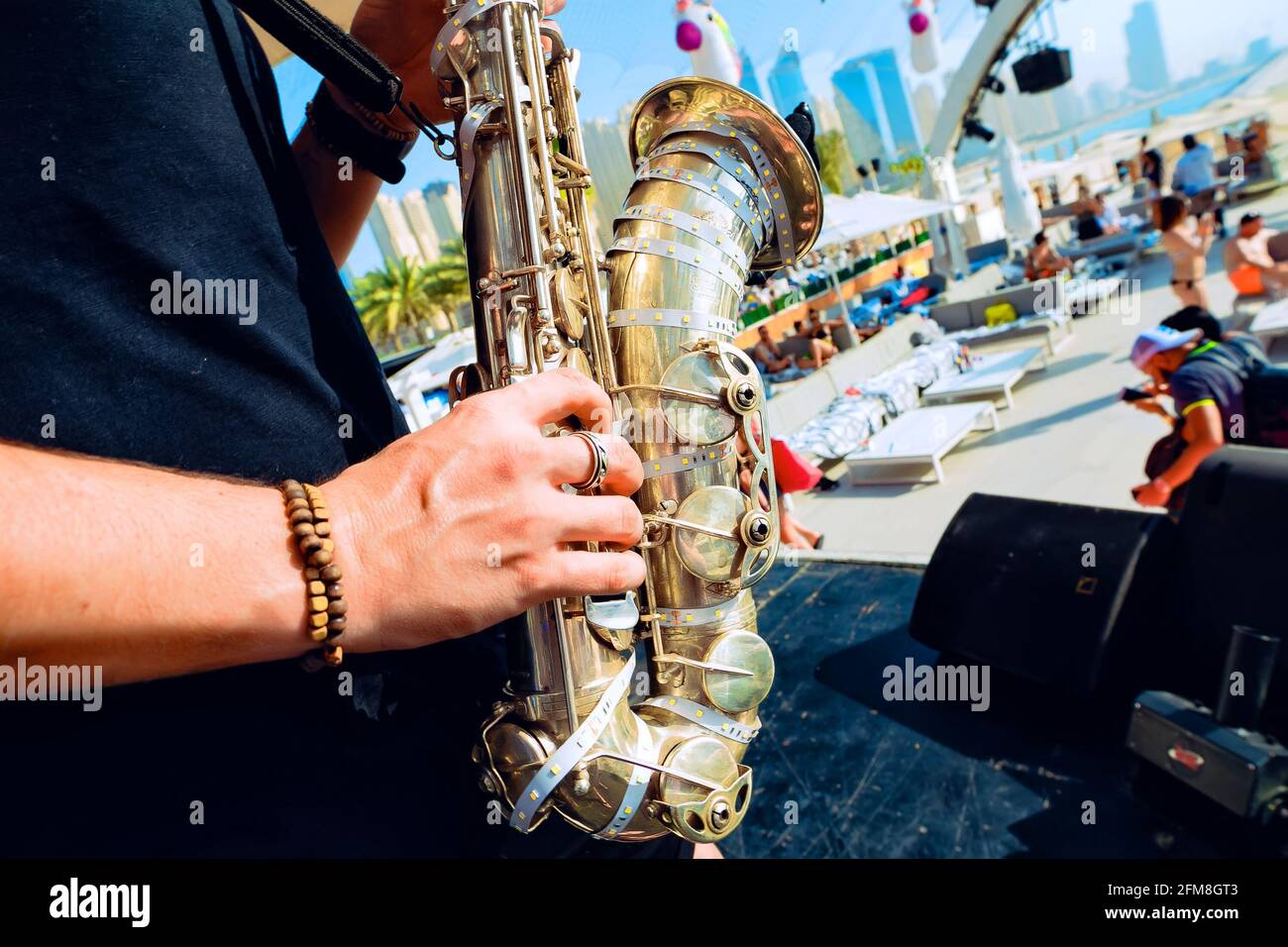 Man playing saxophone outdoors at brunch Stock Photo