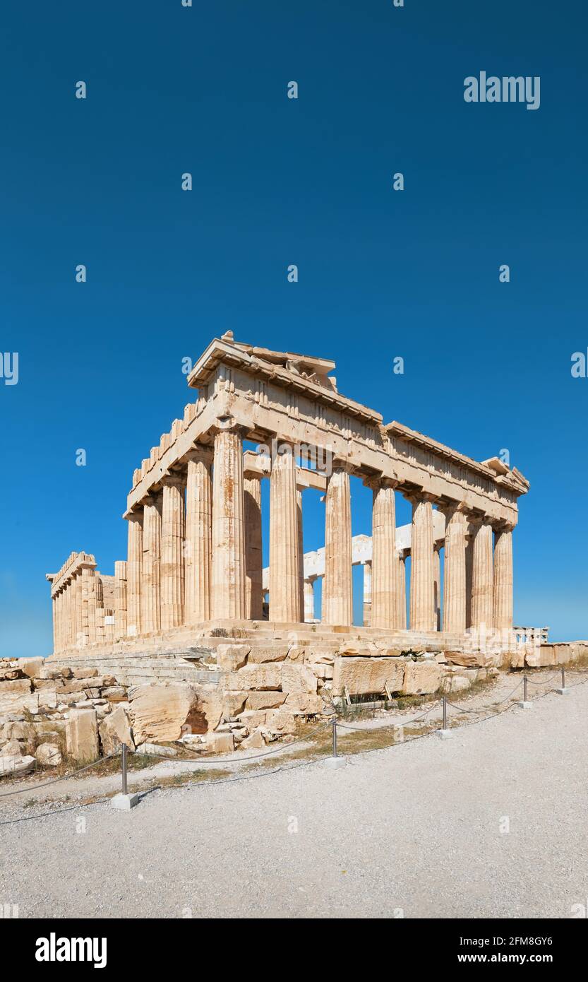 Parthenon temple on a bright day with blue sky and clouds. Panoramic image of ancient buildings in Acropolis hill in Athens, Greece. Classical ancient Stock Photo