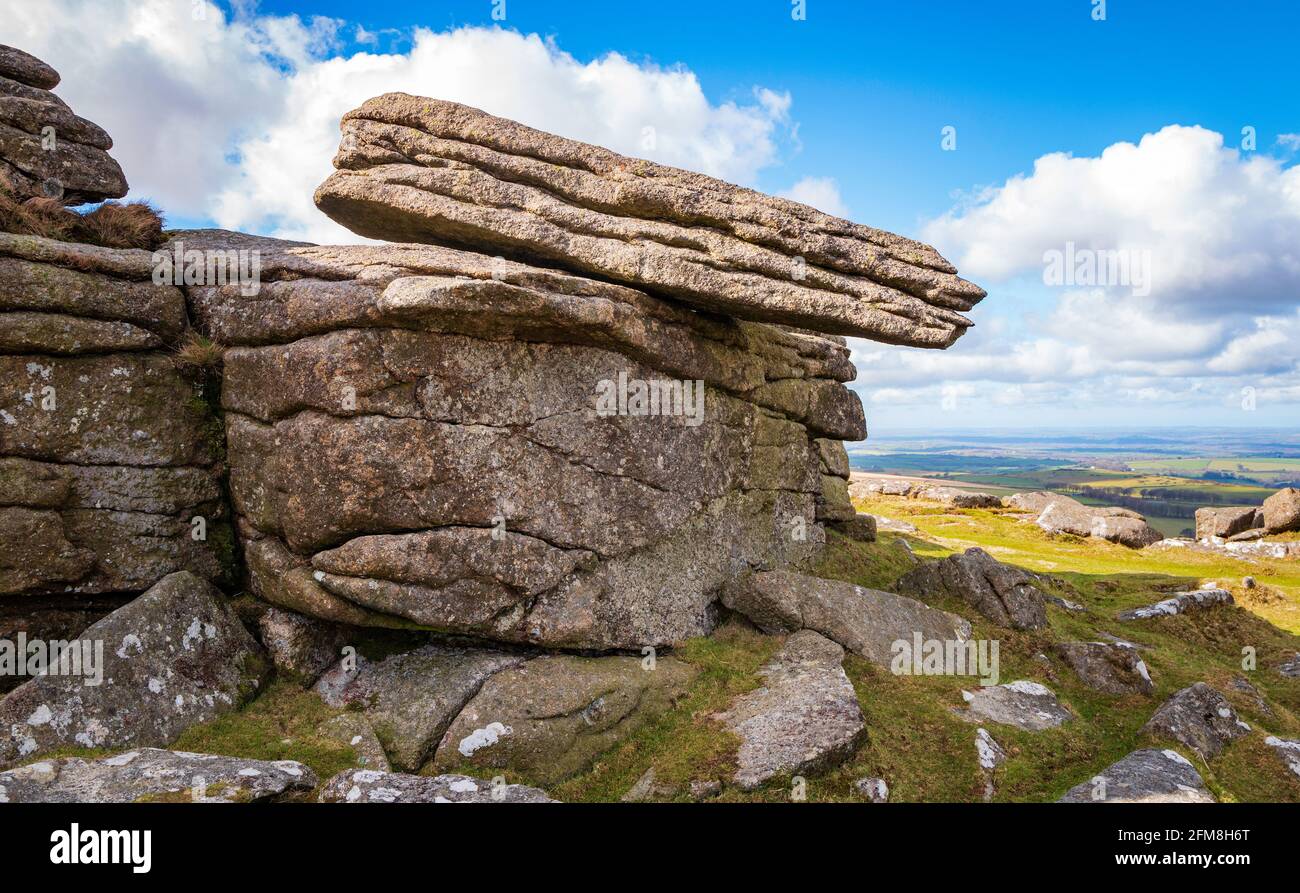 Granite slab, apparently balanced on a rock outcrop, Belstone Tor, Dartmoor National Park, Devon, England, UK Stock Photo