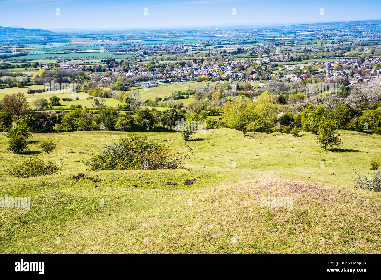 Spring view over the Worcestershire town of Broadway and the Vale of Evesham from the Cotswold Way long distance footpath. Stock Photo
