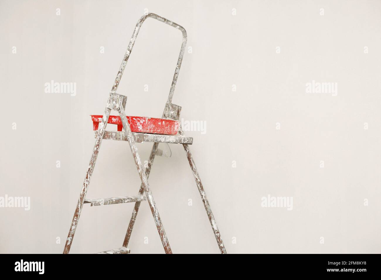 Concept painting work repair painting. metal Ladder, paint cans in a white room for repair Stock Photo