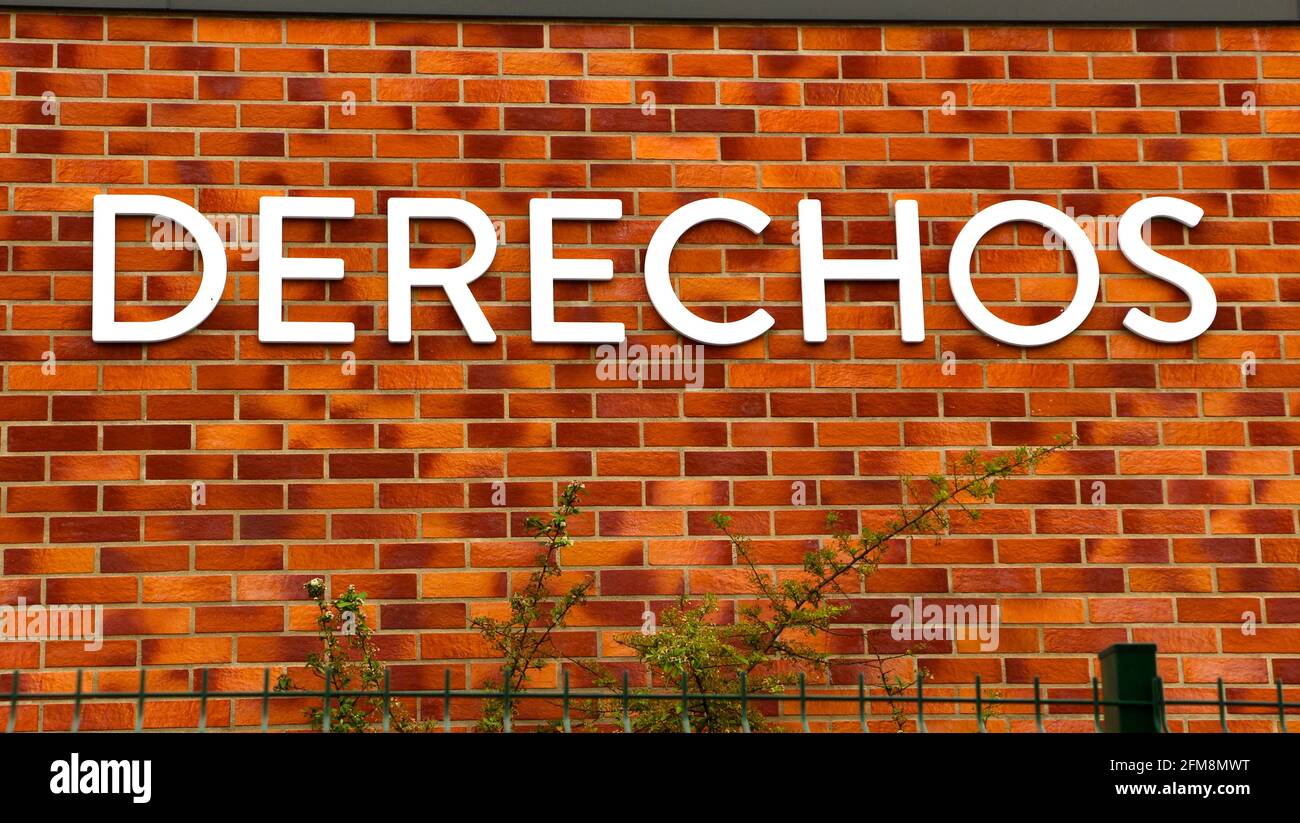Spanish school sign in large white capital letters on a brick wall in Santander Cantabria Spain Stock Photo