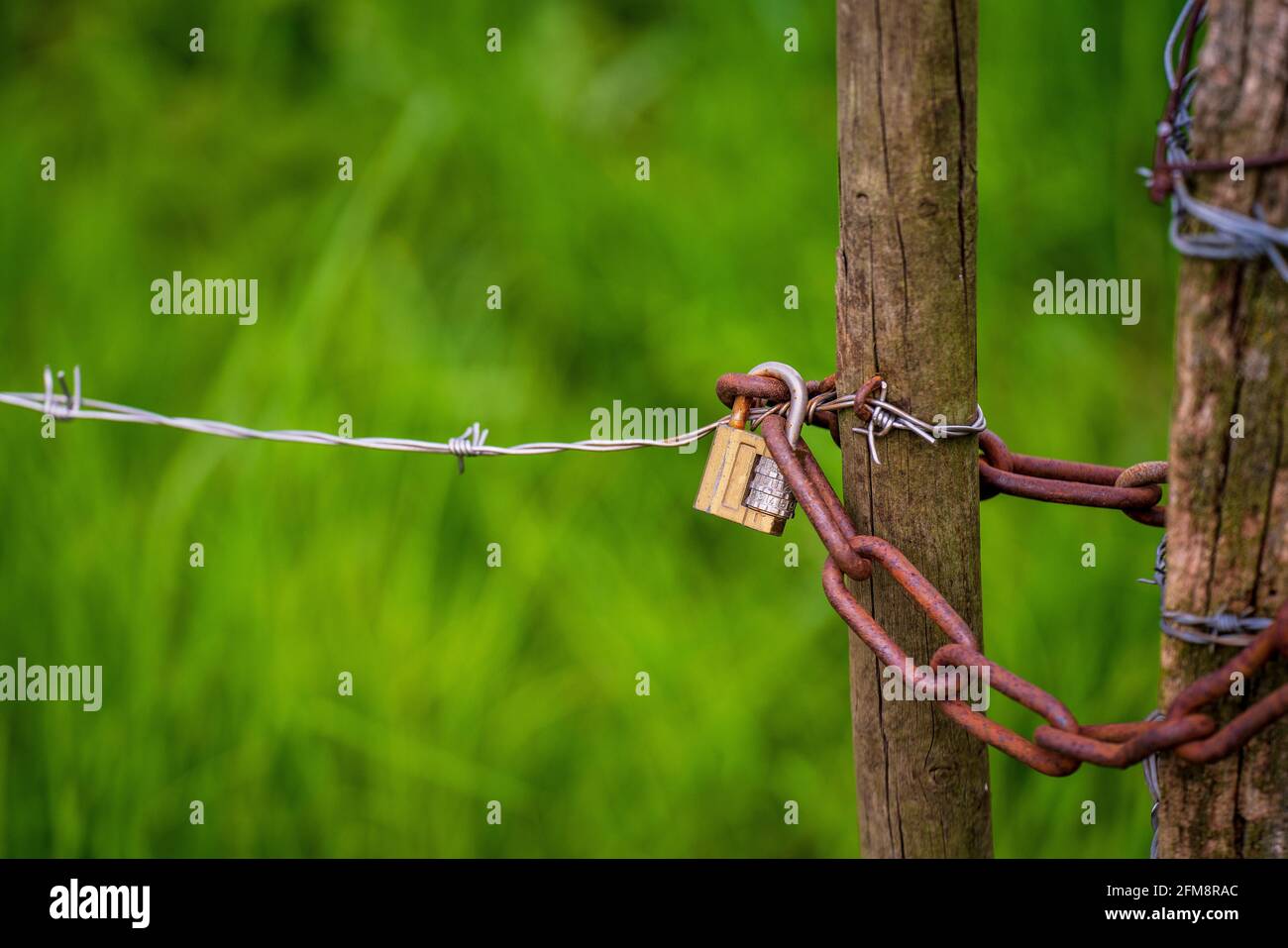 Padlock with a three digit combination on a fence. Stock Photo