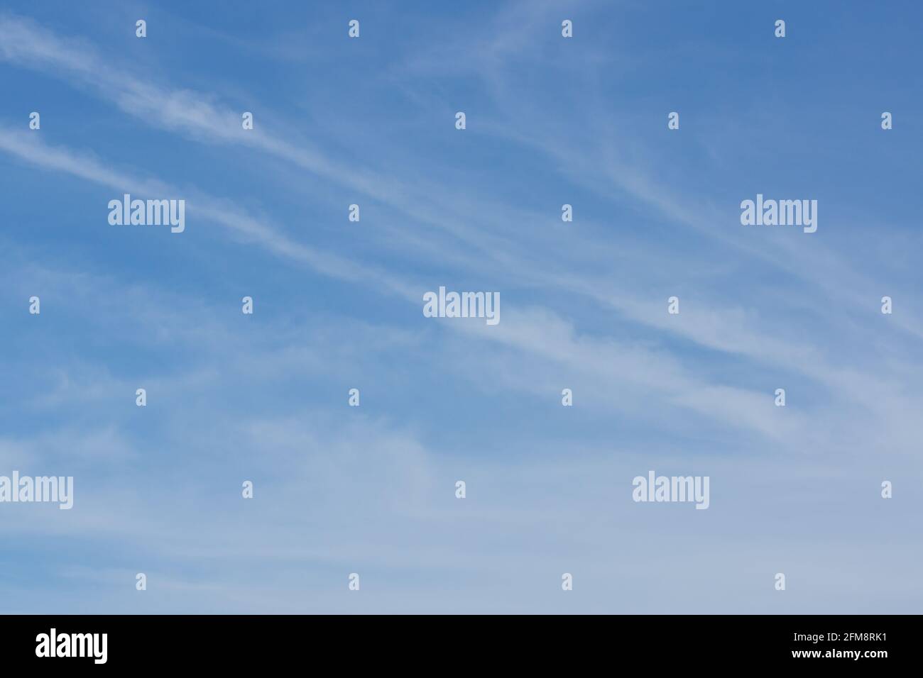 Blue summer sky with whispy white high altitude cirrus clouds Stock Photo