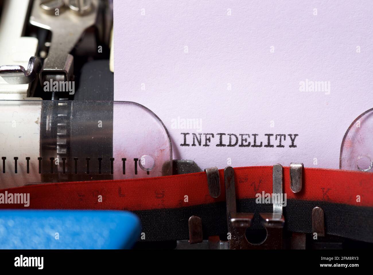 Infidelity word written with a typewriter. Stock Photo