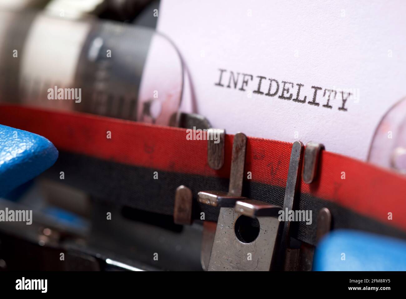 Infidelity word written with a typewriter. Stock Photo