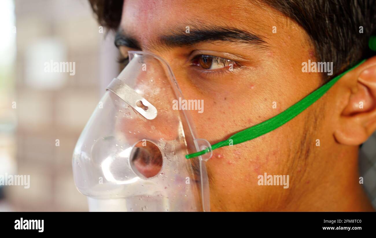 30 April 2021- Reengus, Sikar, India. Teen boy side view shot wearing Oxygen supply Canula with during covid 19 pandemic. Infected n Corona patient ta Stock Photo