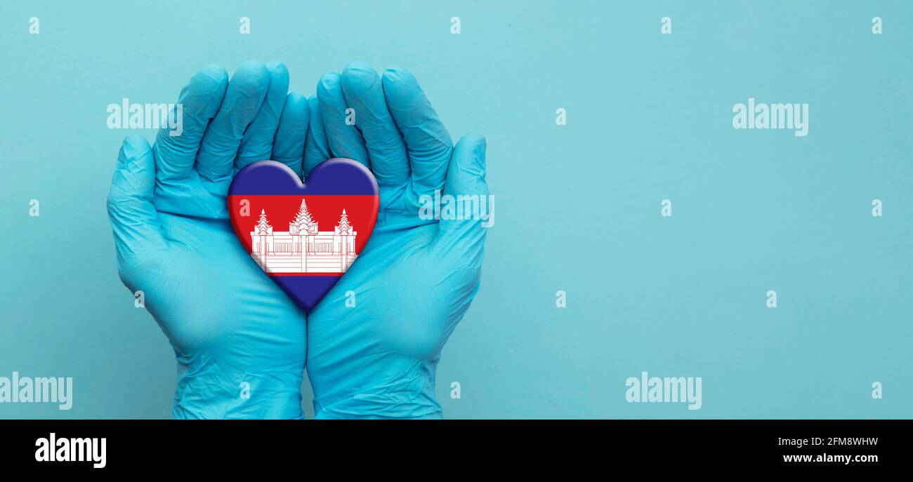 Doctors hands wearing surgical gloves holding Cambodia flag heart Stock Photo Alamy