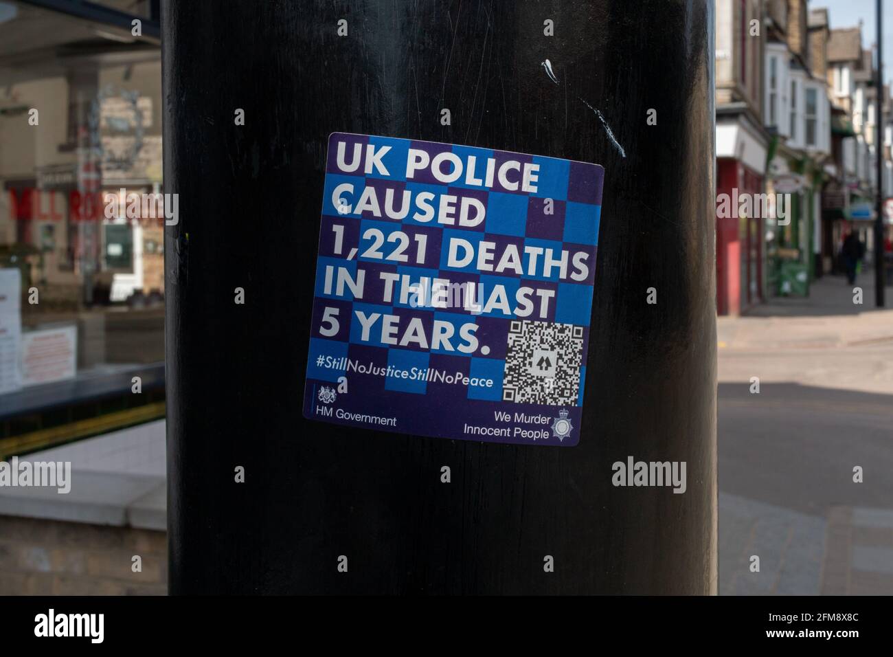 A blue anti-police sticker claiming the UK police caused 1221 deaths in the last five years. Stock Photo