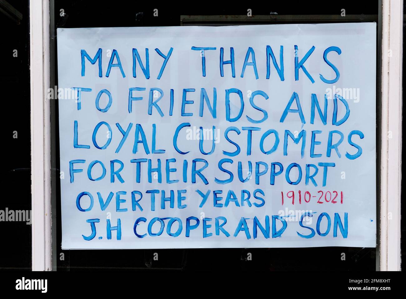 Signs in the windows of Cooper's Furniture shop as it ends trading