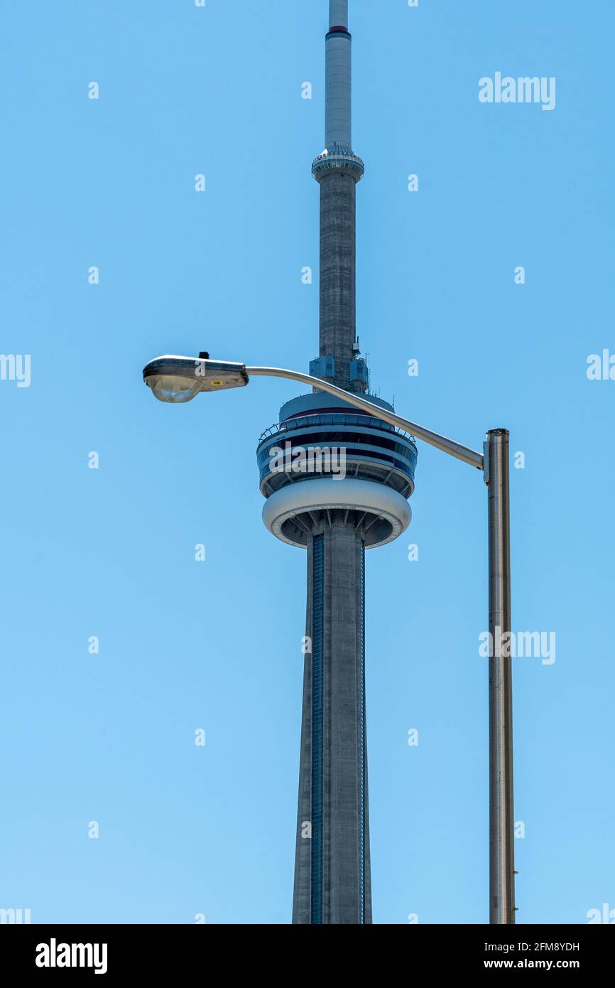 CN Tower or Canadian National Tower framed in an electric lamp in the downtown district of Toronto, Canada Stock Photo