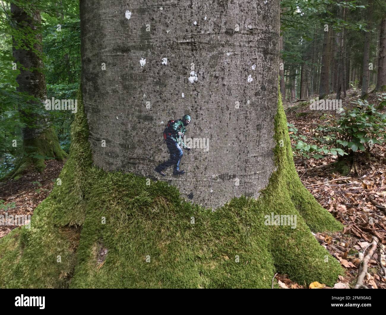 WESTON-SUPER-MARE, UK: A mountaineer appearing to walk a slackline. THIS BRITISH graffiti artist has created a quirky series of mind-bending interacti Stock Photo