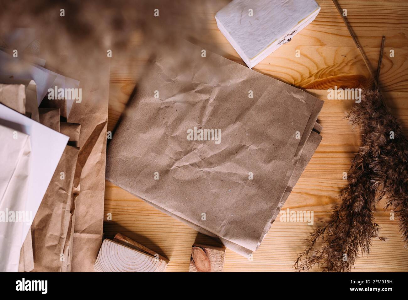 Dry reeds, reeds in retro vase, wood and neutral colors. Mockup craft paper. Stock Photo