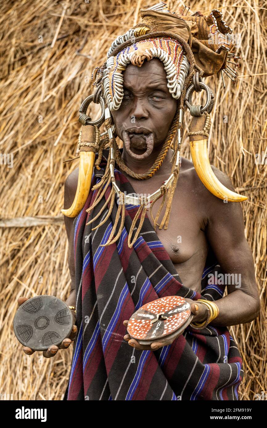 The tribe remove their lip plates for activities like talking and eating. DEBUB OMO ZONE