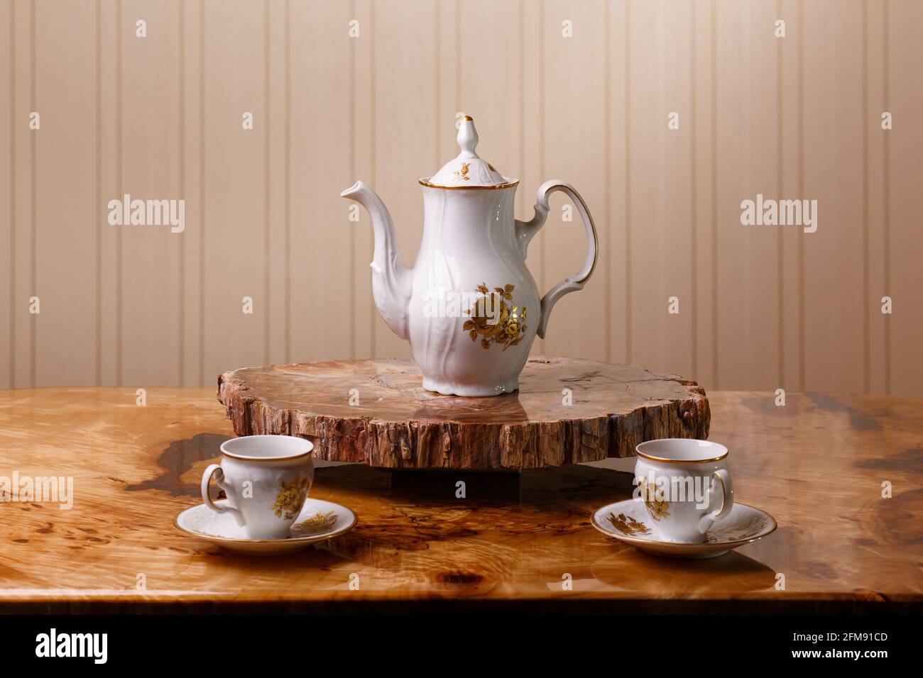 Elegant coffee set on an exclusive tray made from a cut of ancient petrified wood Stock Photo