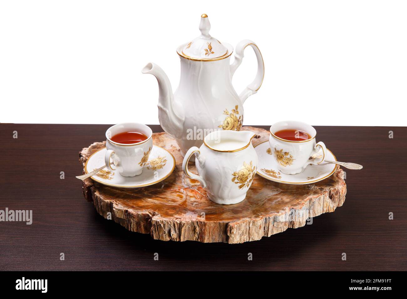 Elegant coffee set on an exclusive tray made from a cut of ancient petrified wood Stock Photo