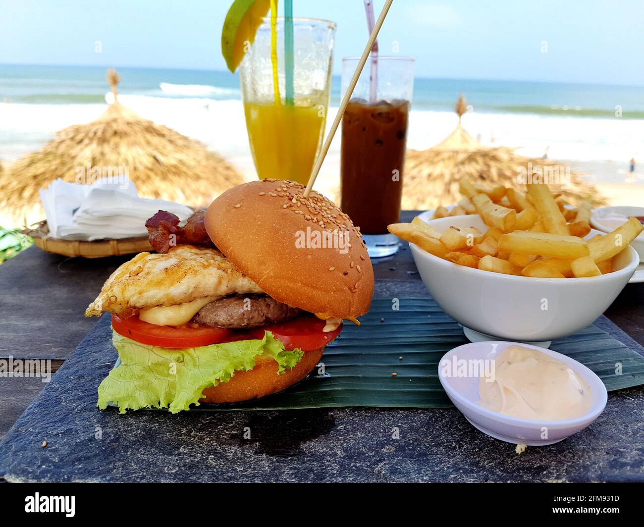 Hamburger and french fries at the beach cafe Stock Photo - Alamy