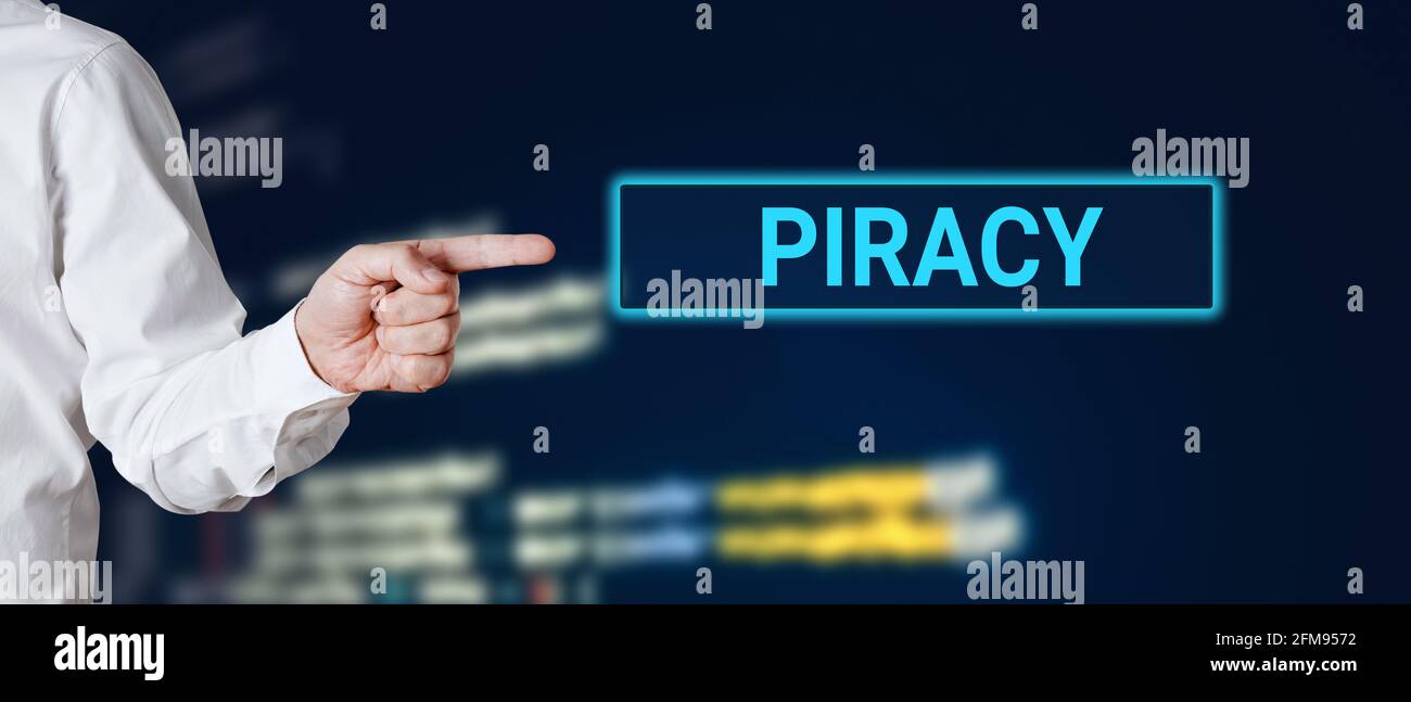Male hand points to the word piracy. Internet technology cyberspace piracy crime concept. Stock Photo