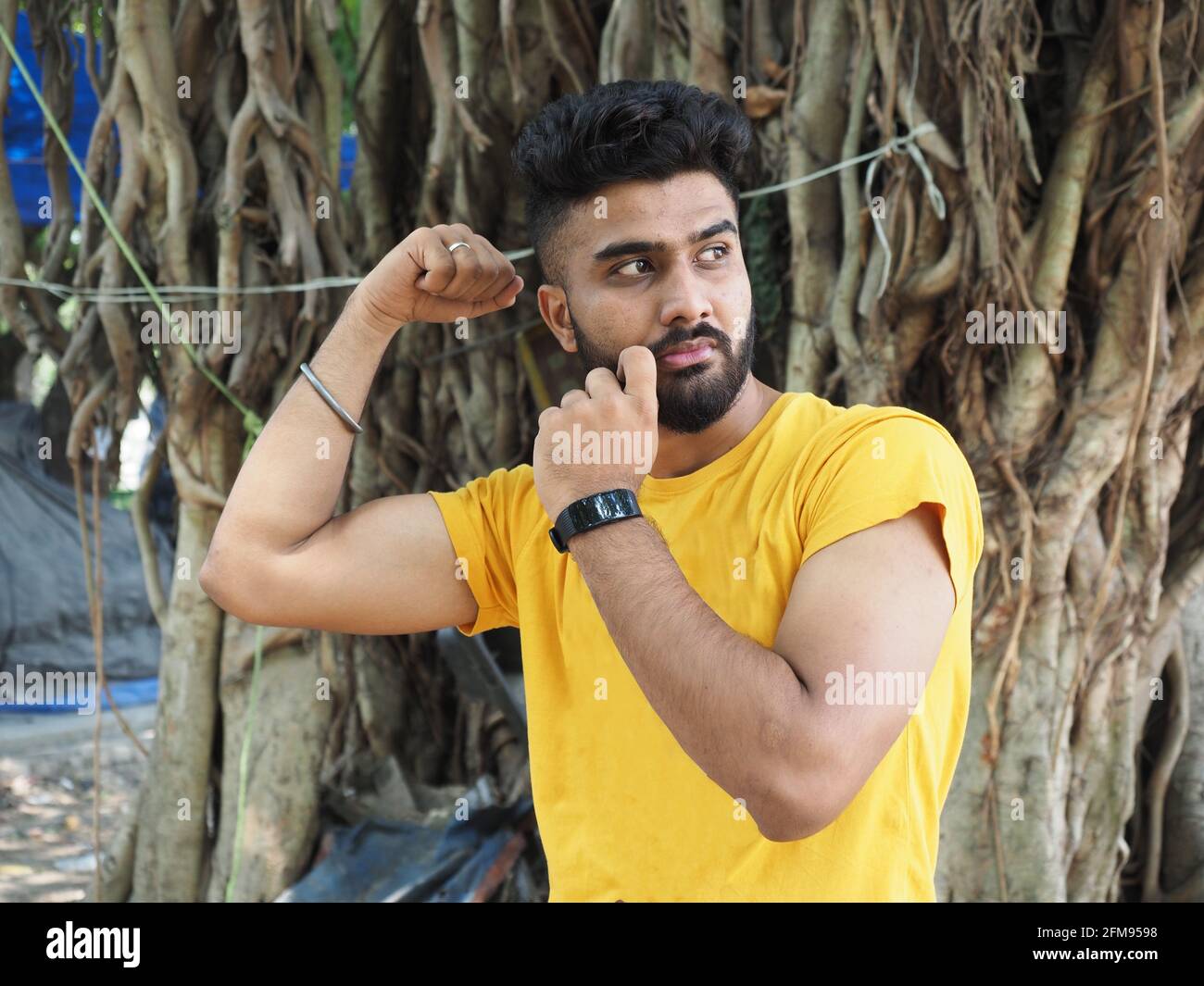 South indian man showing biceps hi-res stock photography and images - Alamy