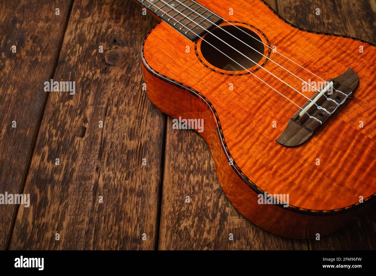 Ukulele Hawaiian guitar on wooden backgroun close up Stock Photo Alamy