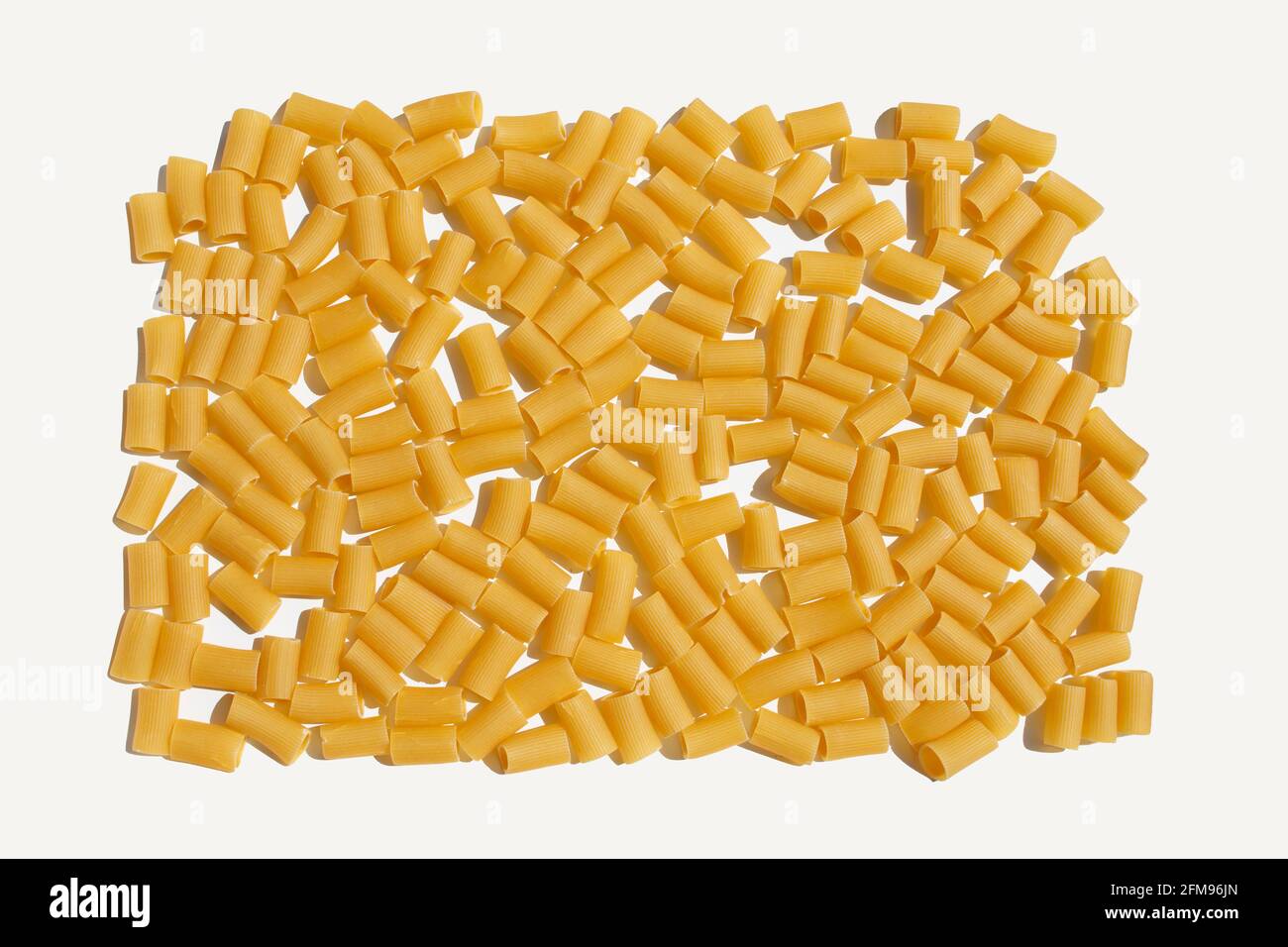 white kitchen table with large group of rigatoni pasta noodles