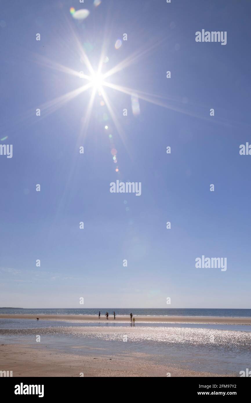 Sunstar over Harlech beach, Gwynedd, Wales Stock Photo