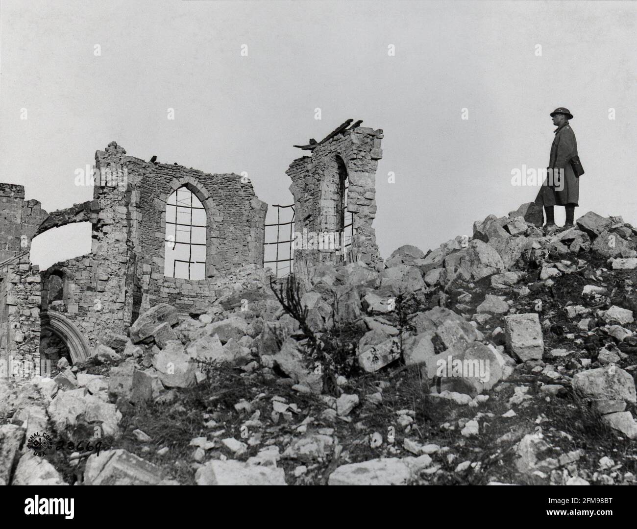 WWI Soldier standing on a pile of rubble of a ruined church  Montfaucon d'Ardenne  Americans drove the Germans out Stock Photo