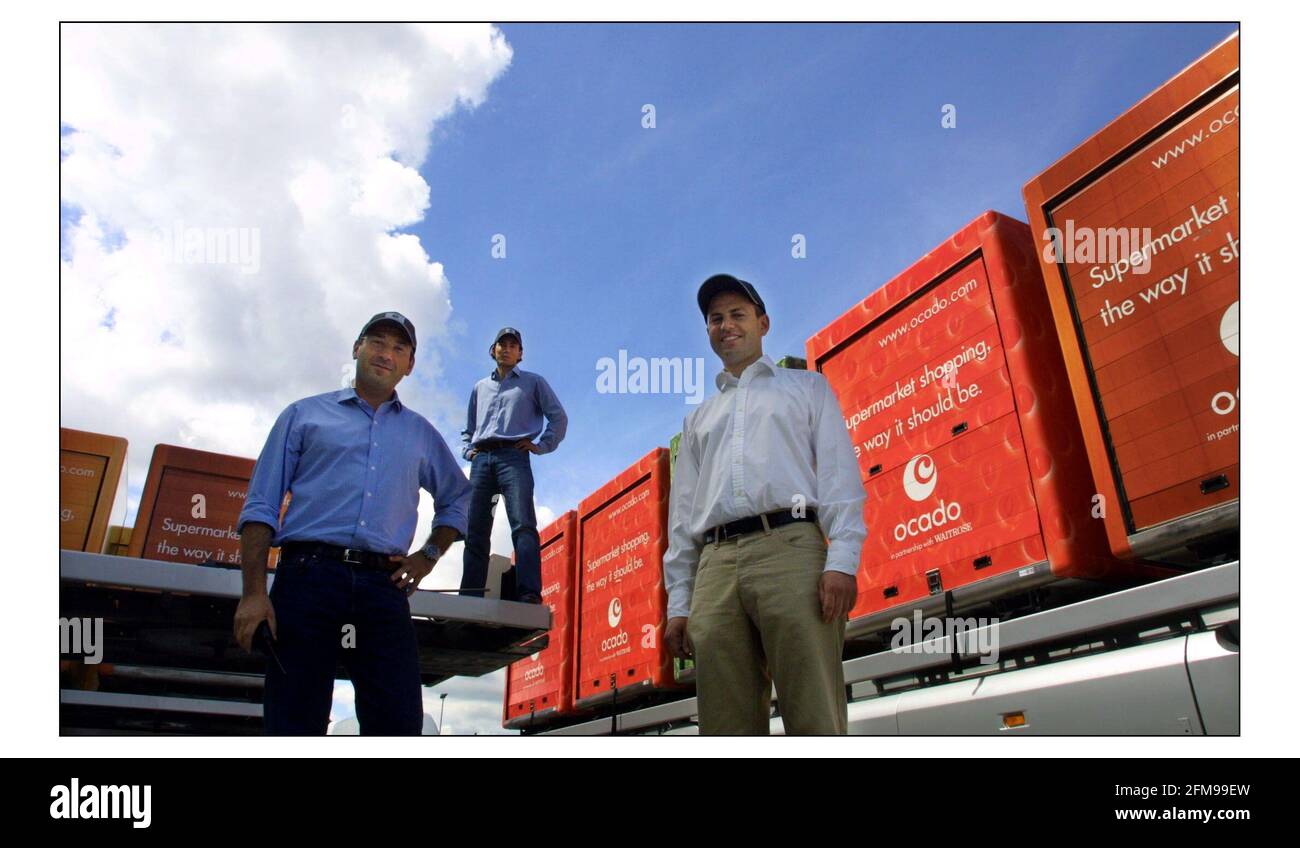 'OCADO' in partnership with Waitrose, a internet shopping company. Three founders (l to R) Jonathan Faiman, Jason Gissing and Tim Steiner with delivery containers outside the warehouse in Hatfield, Herts.pic David Sandison 28/7/2003 Stock Photo