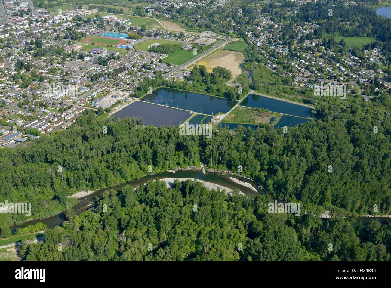 Aerial photo of the Joint Utilities Sewage Lagoons Treatment Plant with the Cowichan River in the foreground, Duncan, Vancouver Island, British Columb Stock Photo
