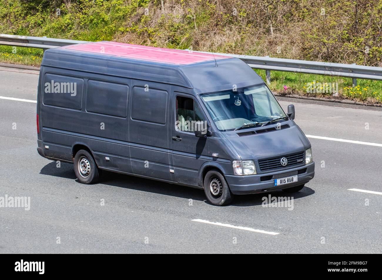 2004 VW Volkswagen Lt35 Tdi LWB high-roof Lasten Transporter panel van; Vehicular traffic, moving vehicles, heavy load cargo transporter vehicle driving on UK roads, motors, motoring on the M6 motorway highway UK road network. Stock Photo