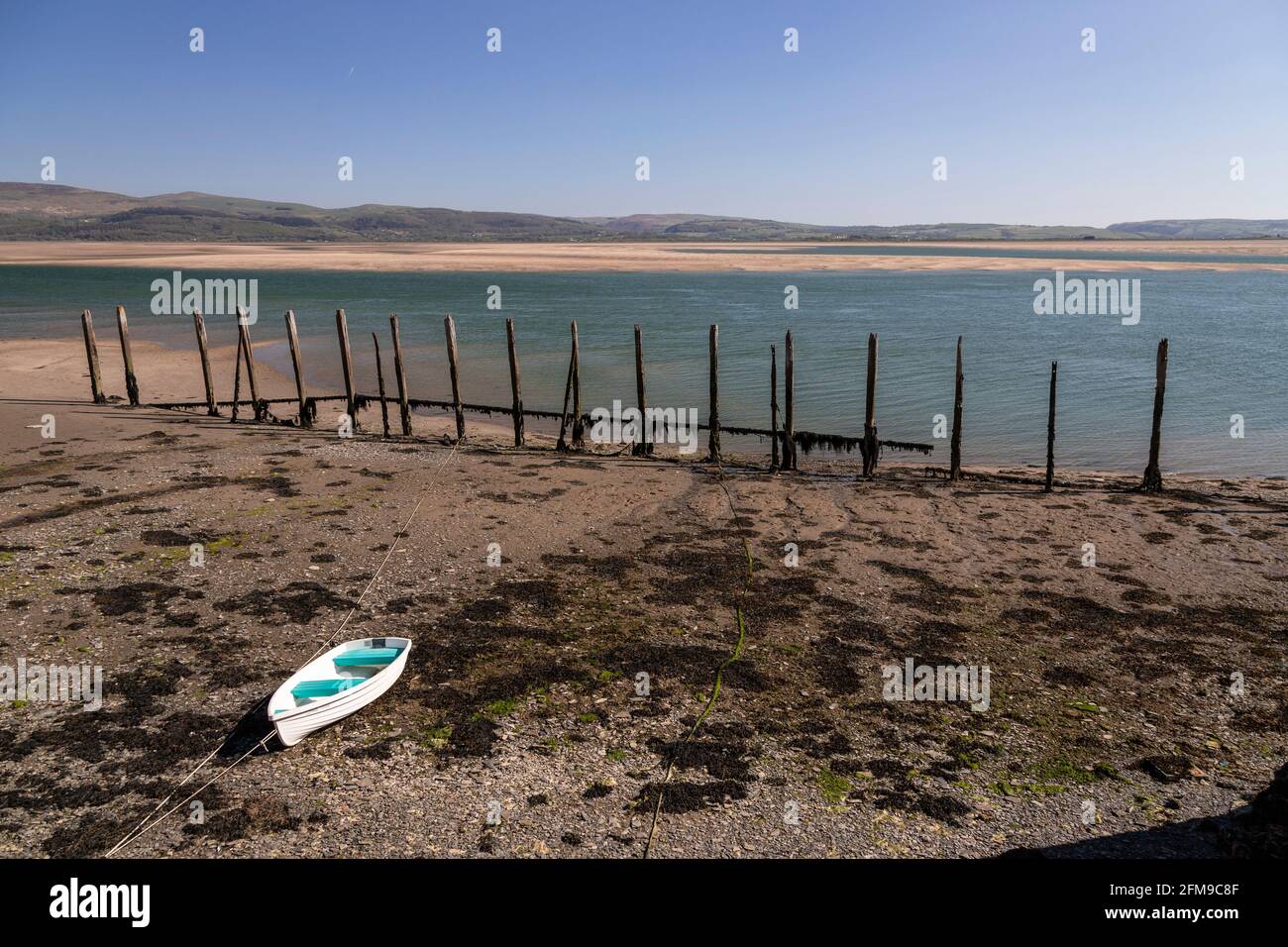 Small boat on sand at Aberdyfi on the welsh coast Stock Photo