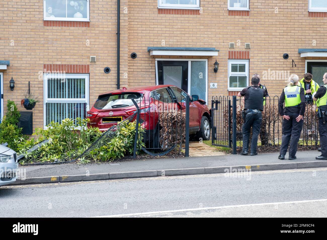 Car crash in front garden of house, Brownhills, UK Stock Photo