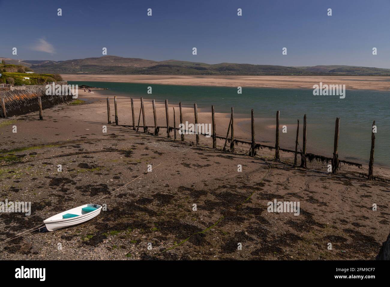 Small boat on sand at Aberdyfi on the welsh coast Stock Photo