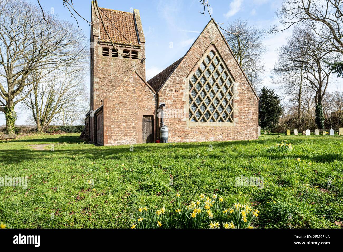 The 20th century Arts & Crafts Movement church of St Edward built of local red sandstone in the village of Kempley, Gloucestershire UK Stock Photo
