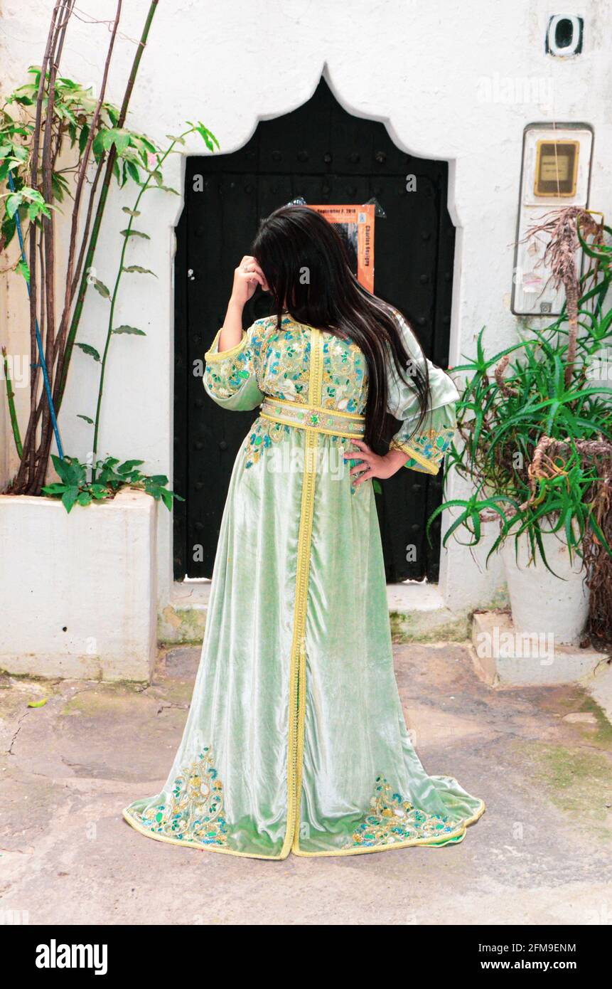 Moroccan model wears a Moroccan caftan. The caftan is a long, flowing type  of robe-like dress that is often worn in Morocco Stock Photo - Alamy