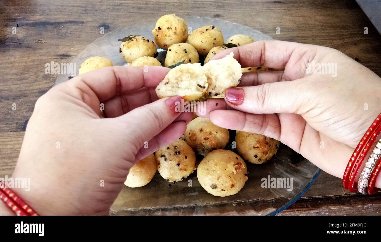 Suji appe or rice appe or appam, an Indian snack with onion, peanuts and tamarind dip in india Stock Photo