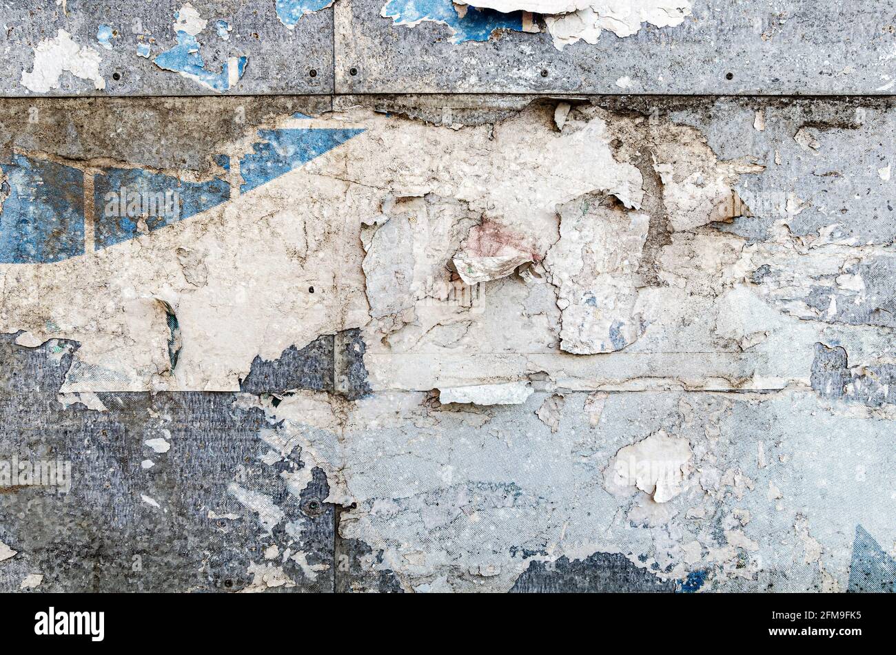 Poster wall texture, grungy background with peeled off dirty papers Stock Photo
