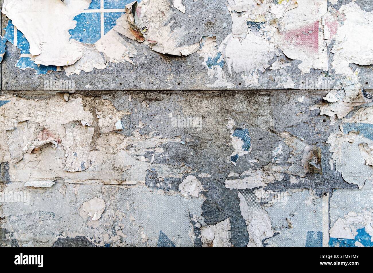 Poster wall texture, grungy background with peeled off dirty papers Stock Photo