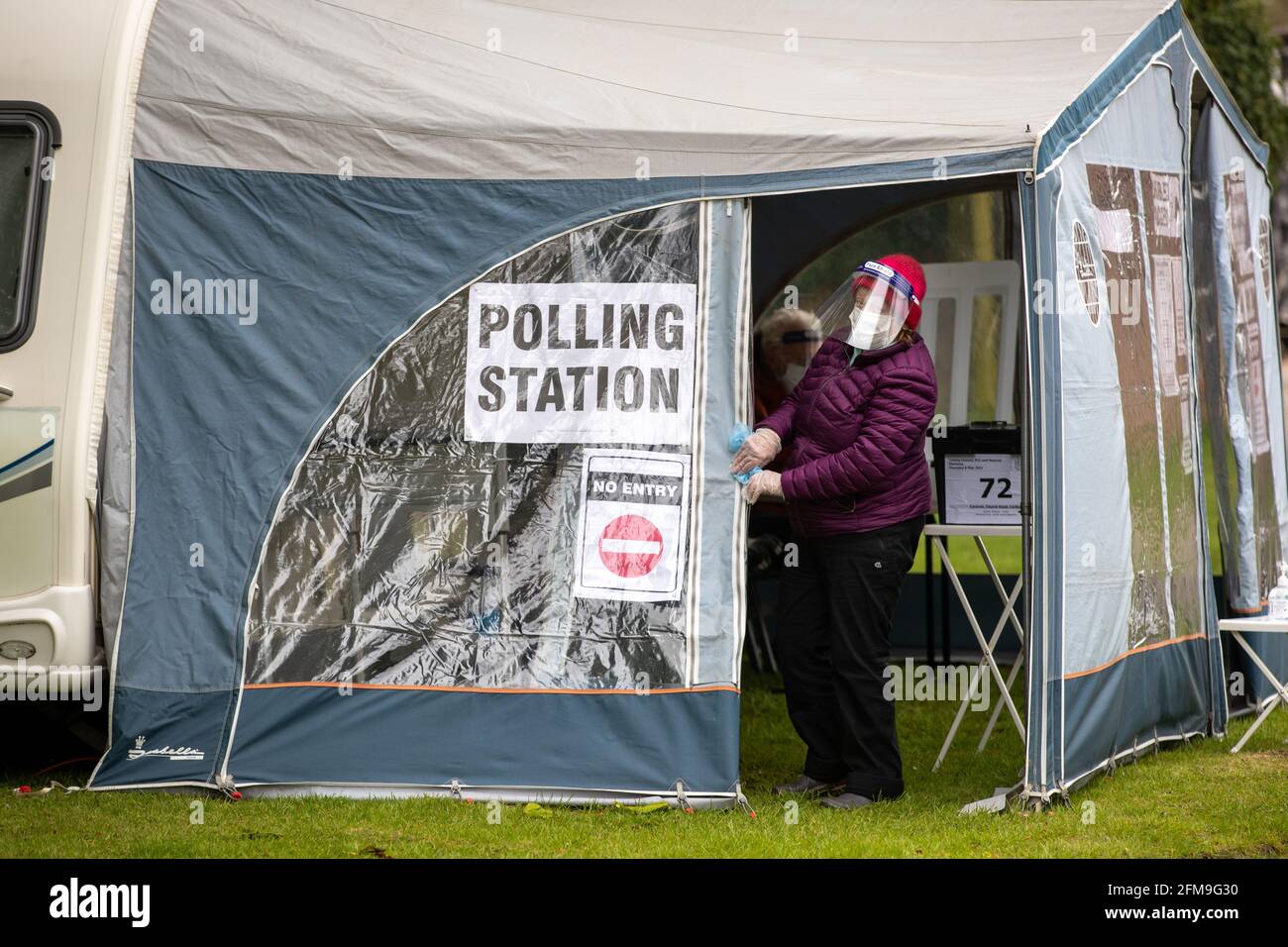 Picture dated May 6th shows people voting in a caravan in the village of Carlton in Cambridgeshire on Thursday morning.  Voters headed to a variety of unusual polling stations across the country for today’s (Thurs) County Council and Police Crime Commissioner elections. Villagers in rural Carlton, near Newmarket in Suffolk, have been voting in a tiny CARAVAN parked outside the Old Rectory. The small caravan pulled-up outside Robin Wylie’s house last night and around 100 people are expected to vote there today. The polling stations will close at 10pm tonight and results will be announced throug Stock Photo