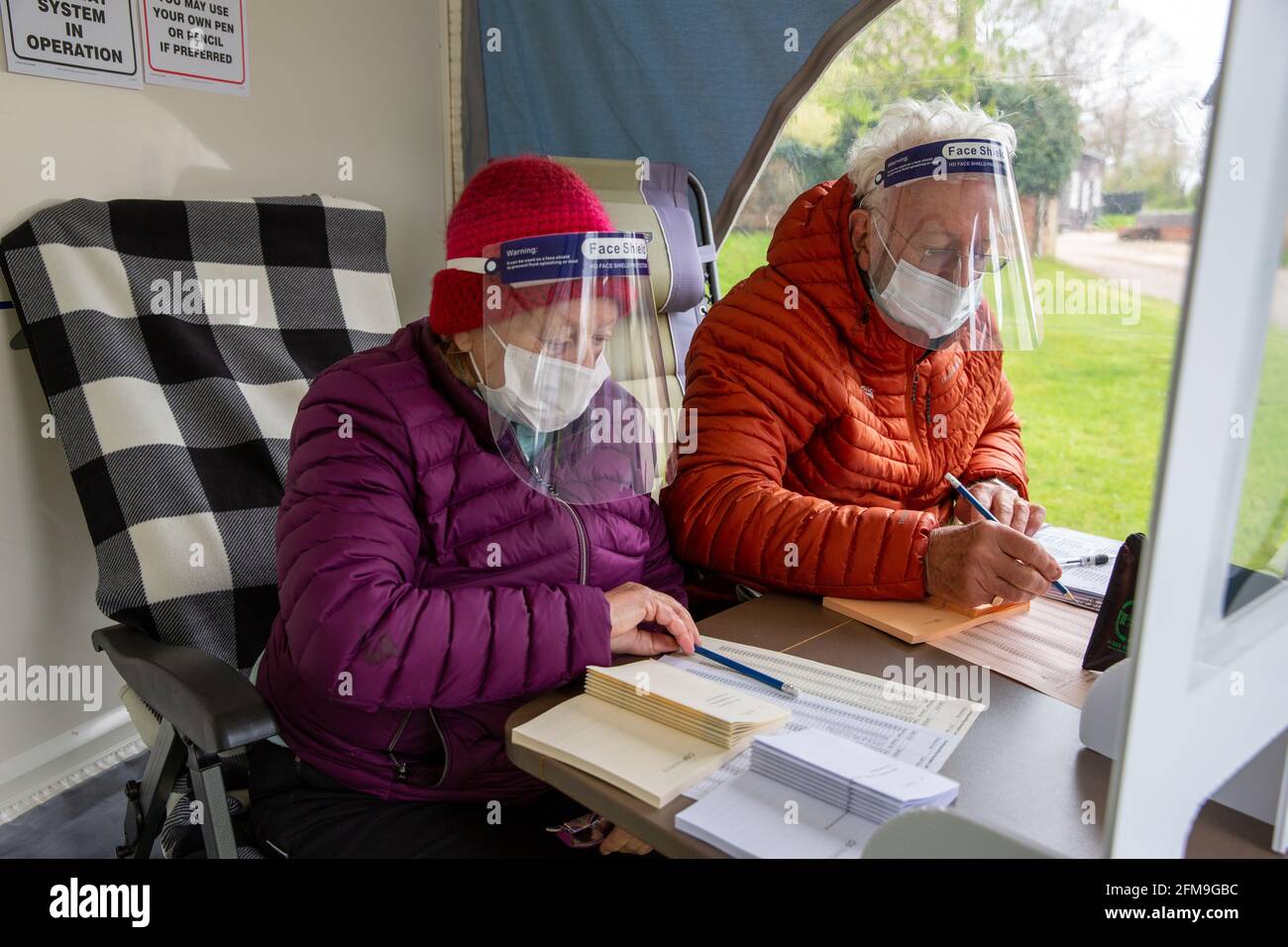 Picture dated May 6th shows people voting in a caravan in the village of Carlton in Cambridgeshire on Thursday morning.  Voters headed to a variety of unusual polling stations across the country for today’s (Thurs) County Council and Police Crime Commissioner elections. Villagers in rural Carlton, near Newmarket in Suffolk, have been voting in a tiny CARAVAN parked outside the Old Rectory. The small caravan pulled-up outside Robin Wylie’s house last night and around 100 people are expected to vote there today. The polling stations will close at 10pm tonight and results will be announced throug Stock Photo