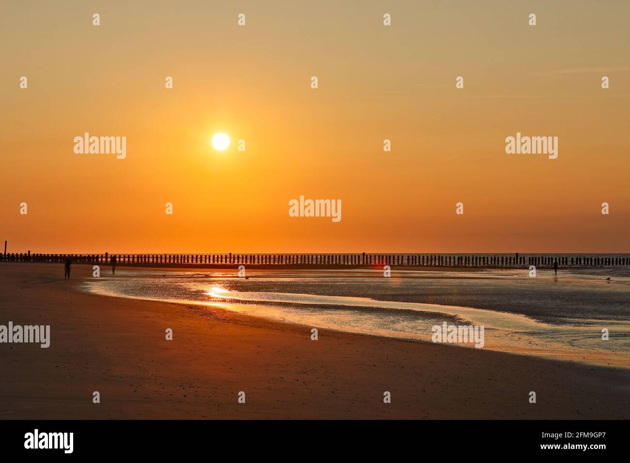 Sunset over the North Sea at low tide on the island of Wangerooge Stock Photo