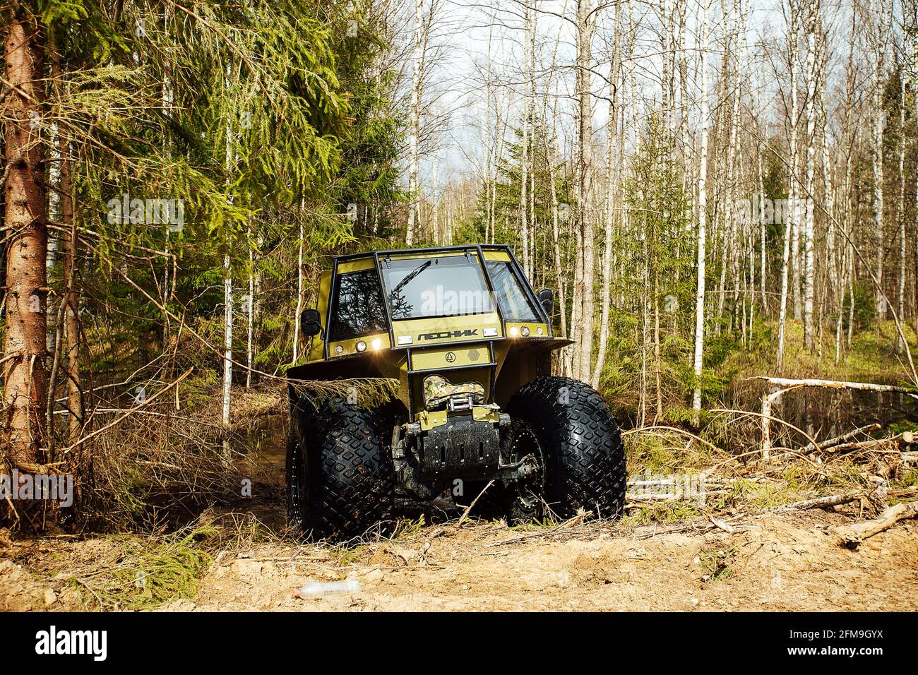 a fourwheel drive allterrain vehicle drives through the forest